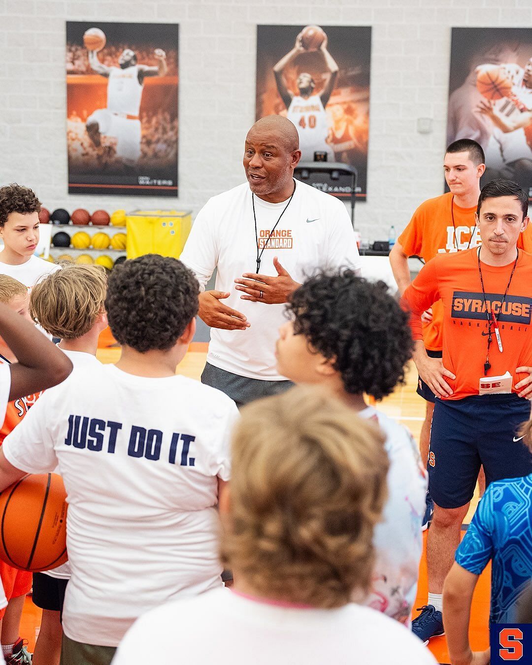 Coaches Peter Corasaniti and Red Autry talking to the young hoopers at the camp (Image via Instagram @cuse_mbb)